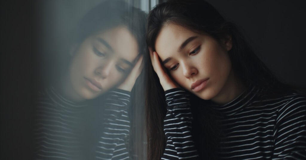 Young woman experiencing emotional distress, representing bipolar disorder and mental health challenges.