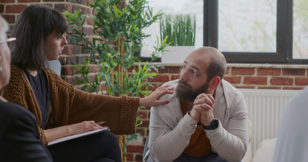 Man receiving support during a relapse recovery session