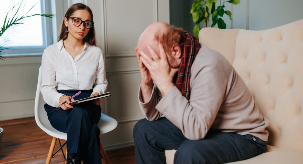 Older man receiving professional support for dementia-related emotional distress