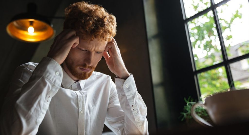 Person experiencing confusion and emotional distress related to psychosis