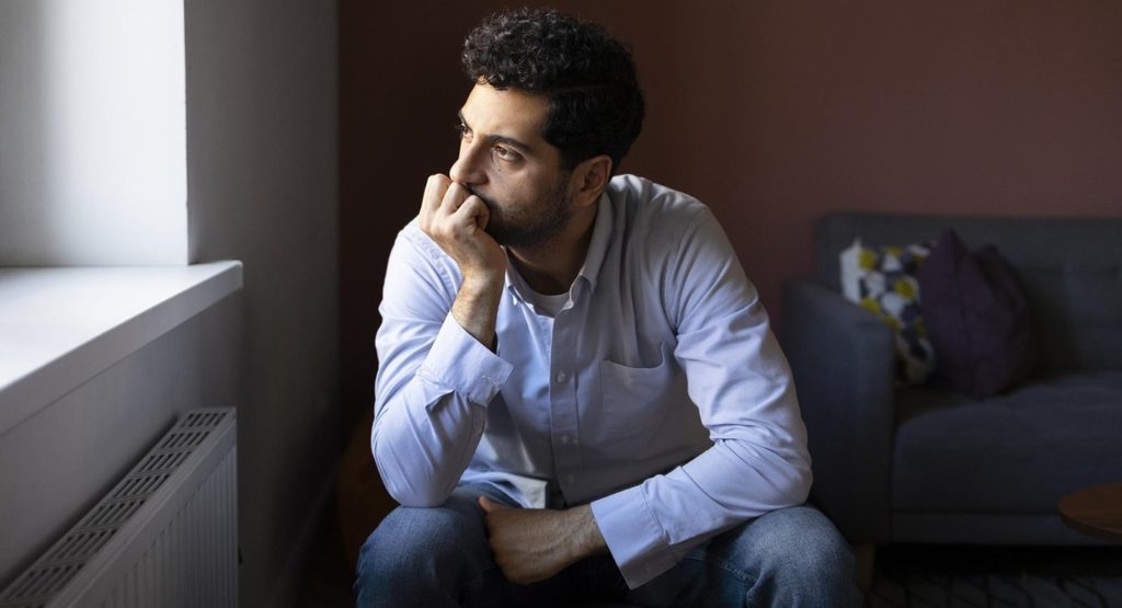 alternative alt text
Man experiencing emotional distress while reflecting alone, representing paranoid personality disorder and persistent feelings of distrust.