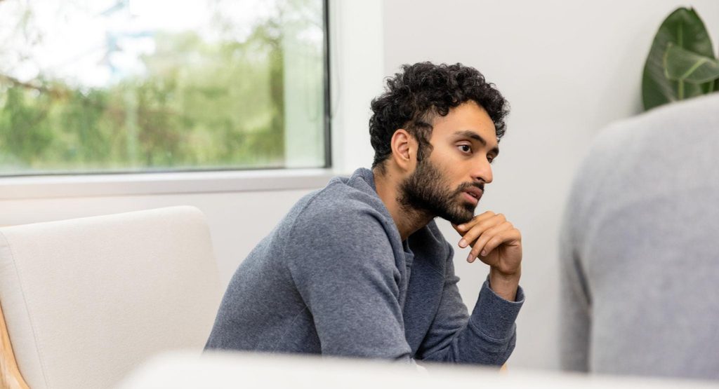 Man receiving mental health support during a consultation.